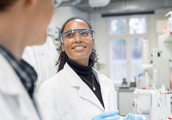 A lab technician talks to her coworker