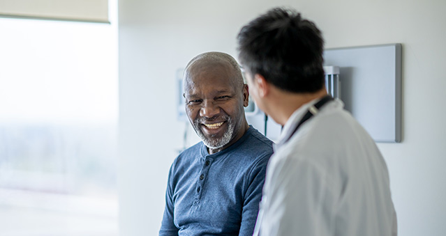 A patient smiles at his doctor